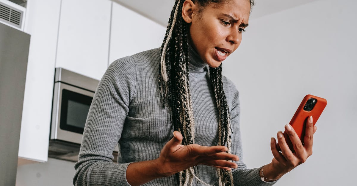 PAL N64 problems with S-VIdeo - Annoyed black woman having video chat on smartphone at home