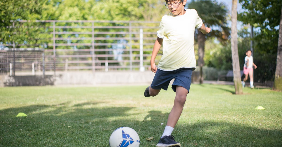 Play 2nd DLC without 1st - Boy in White T-shirt and Black Shorts Playing Soccer