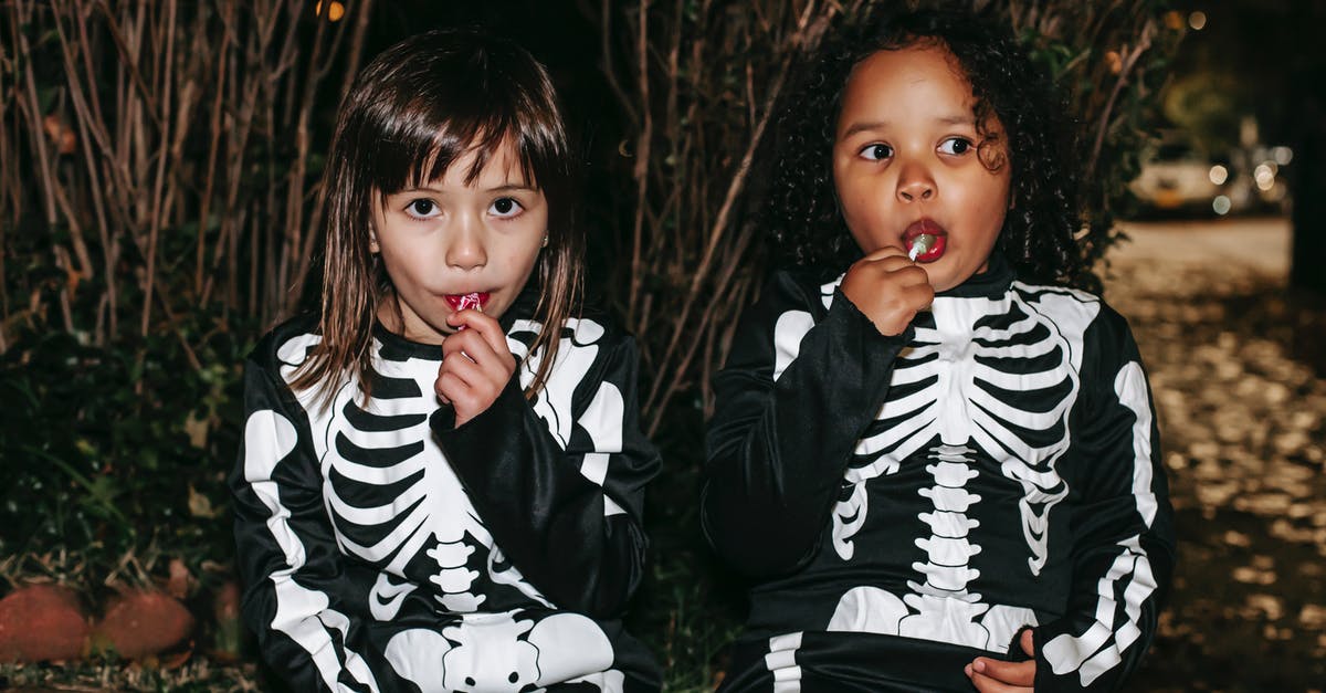 Play custom sound(texturepack) that doesn't exist in Minecraft - Positive little multiracial girls wearing traditional skeleton costumes and enjoying sweet stick candies while sitting on brick border in autumn park after playing Trick or Treat game