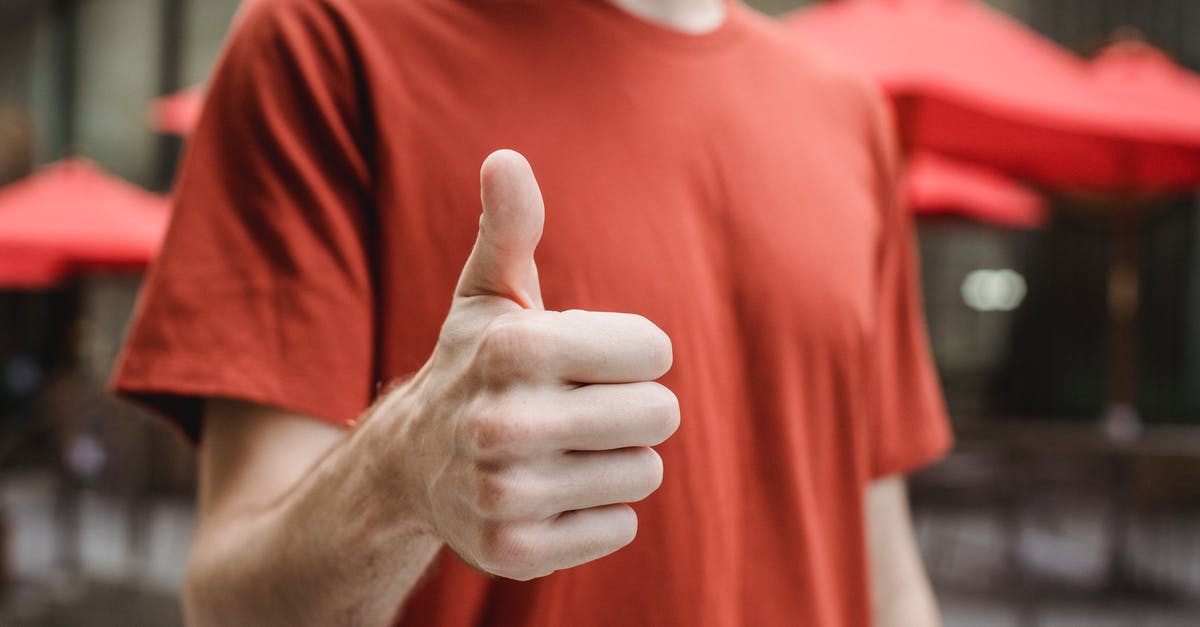 Pointers to closest portals don't show up - Crop anonymous young male in red t shirt showing thumb up gesture while standing on city street on sunny day