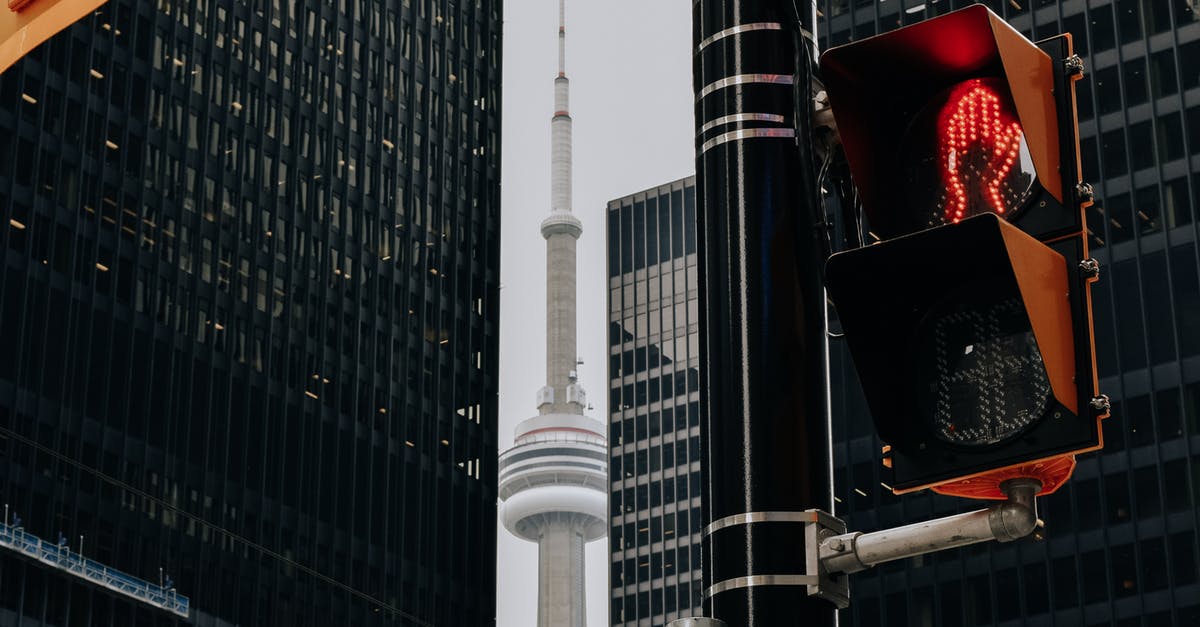 Pokémon gba-gcn compatibility between regions? - Traffic light with red color and TV tower between skyscrapers