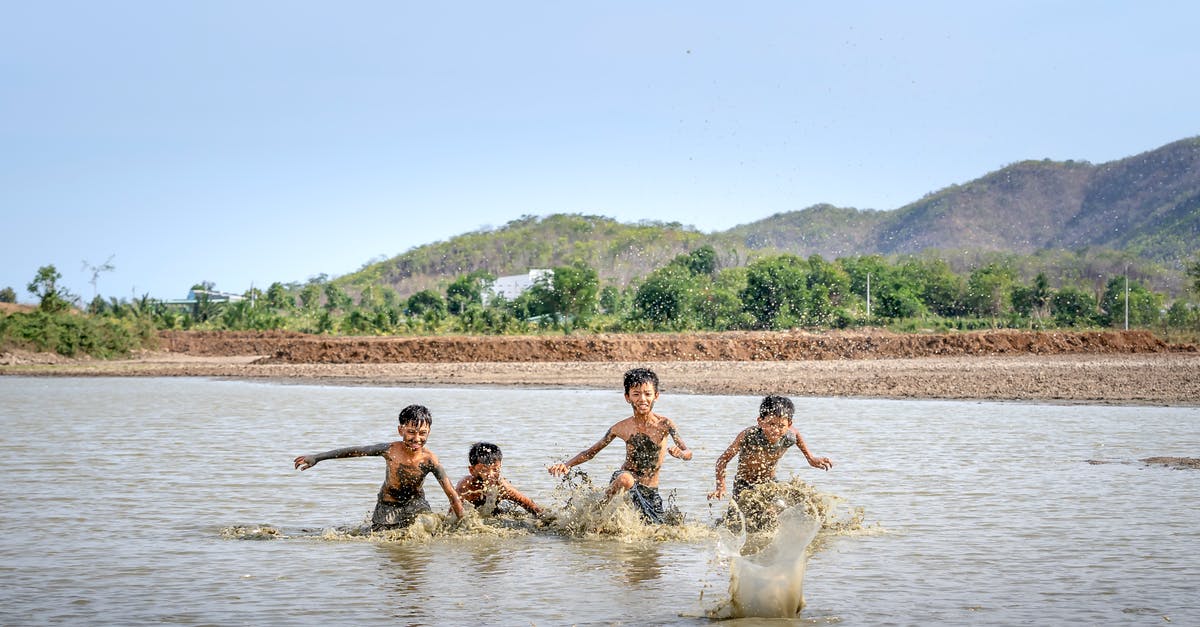 Pokemon Ultra Sun game restarts every time the game is played - Group of playful Asian boys running in river dirty water while playing game in summer day