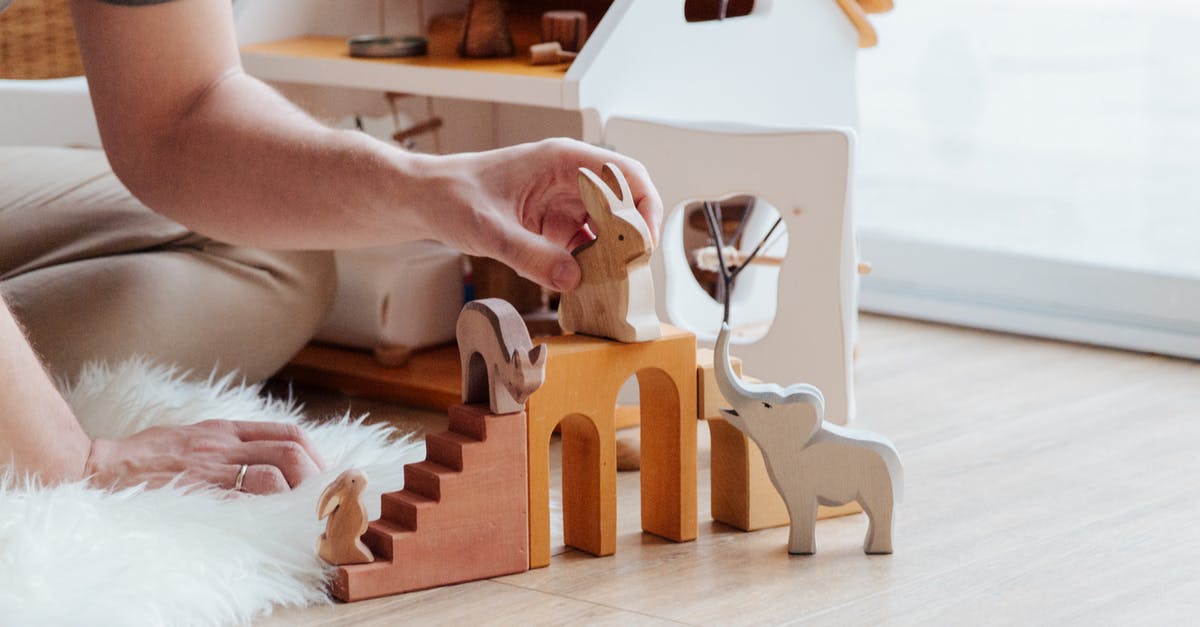 Possible to Accidentally Block the End Game Area? - Anonymous crop parent playing with toys on floor at home