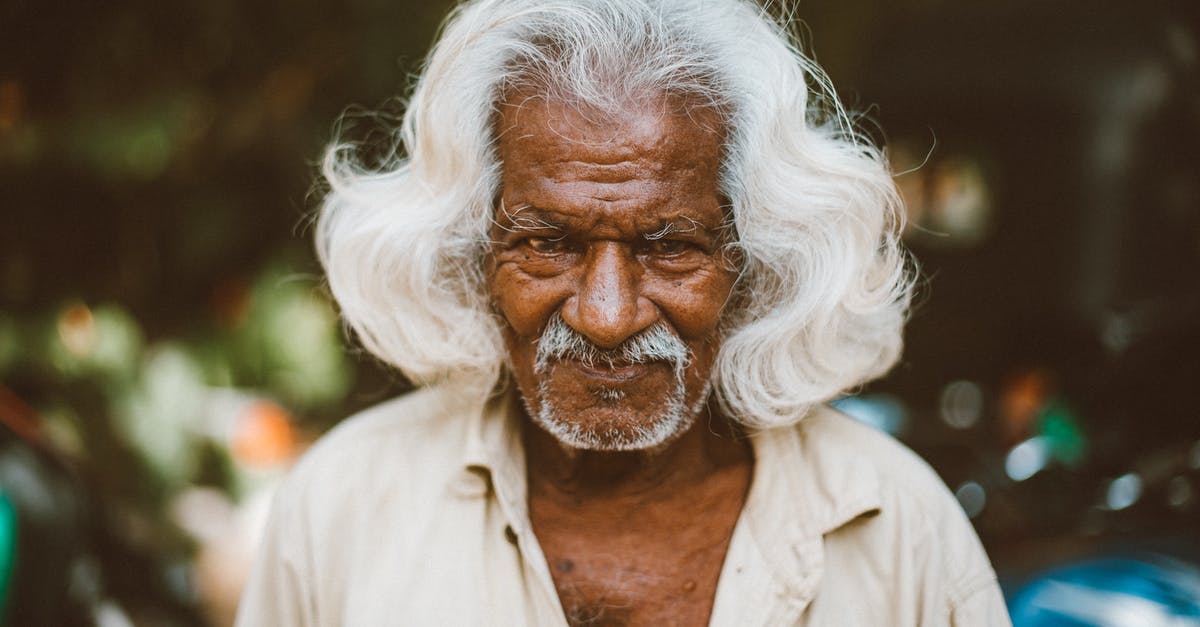 Premature vs Mature town hall - Optimist elderly ethnic man on urban street