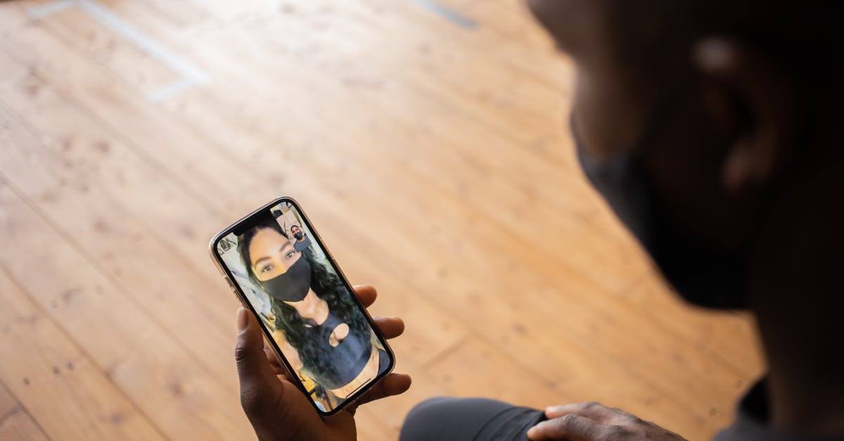 Prevent AI from using Venice - Crop black man talking to girlfriend in mask on smartphone