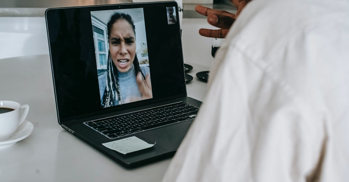 Problem with borderless screen on League of Legends - Unrecognizable ethnic man having video conference with upset girlfriend