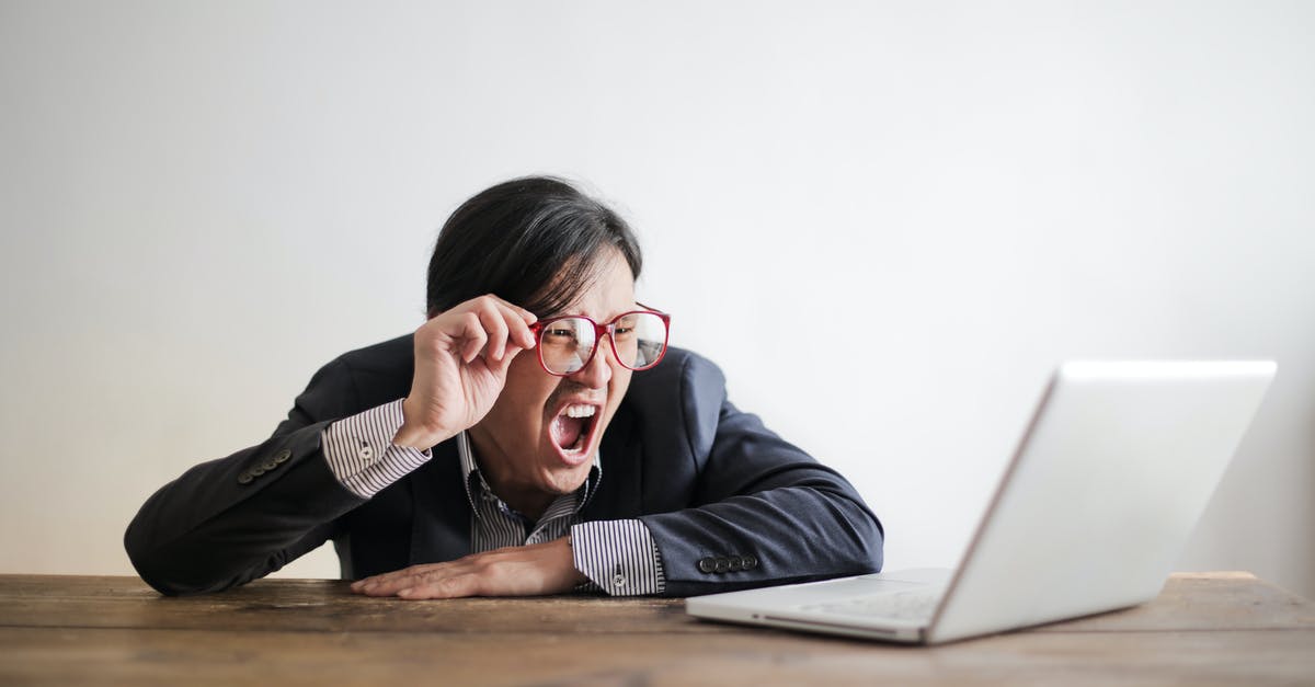 Problems with the Draug boss fight - Modern Asian man in jacket and glasses looking at laptop and screaming with mouth wide opened on white background