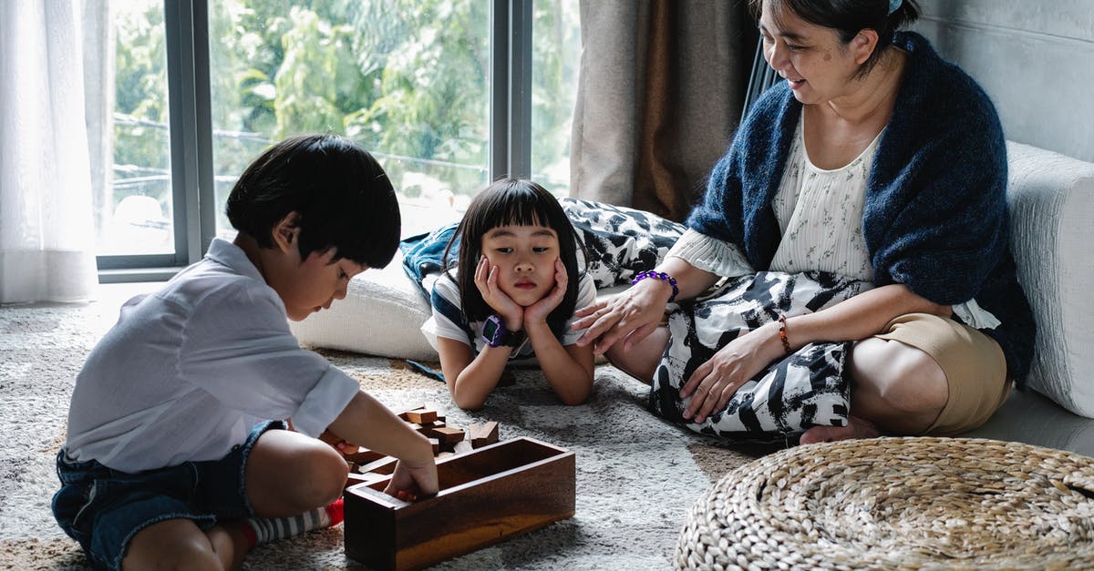 PvZ 2: Charge-up Time at the Beginning of Game - Upset ethnic kid looking at brother picking up blocks after playing game with grandmother