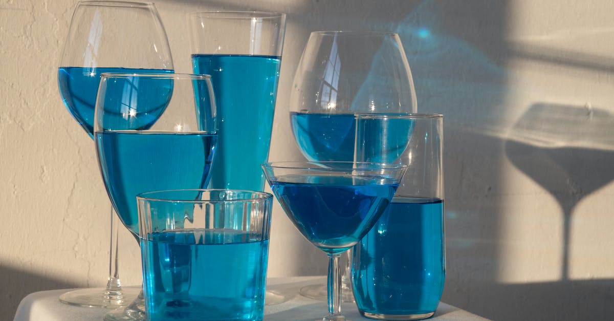 Regenerate Full Health instead of Individual Bars in Mass Effect 3 - Transparent glasses filled with blue alcoholic drink standing on white tablecloth in sunlight