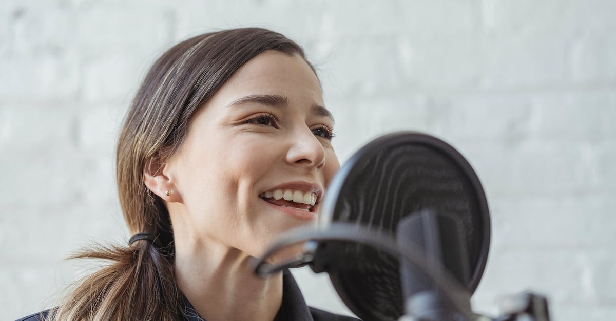 Remove host from host map in Hacknet - Positive female recording podcast on mic while working in light studio against white brick wall