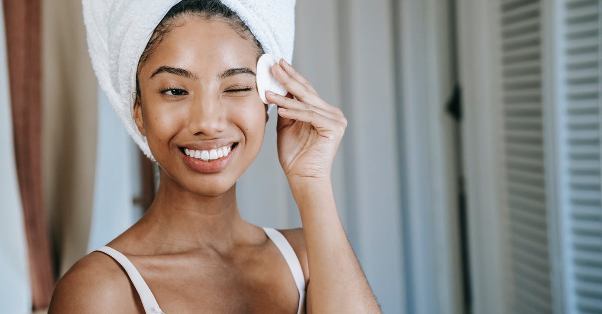 Remove warscore limit - Smiling ethnic woman wiping face skin in morning