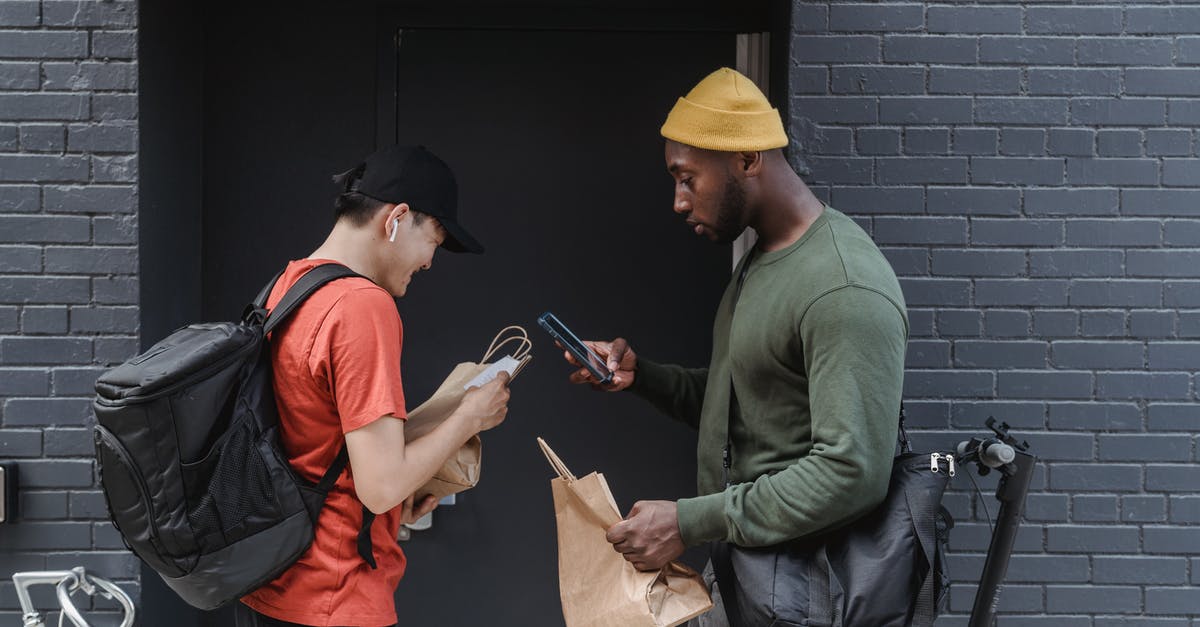 Running client sided convars on the server in CS:GO - Man in Green Jacket and Orange Apron Holding Smartphone