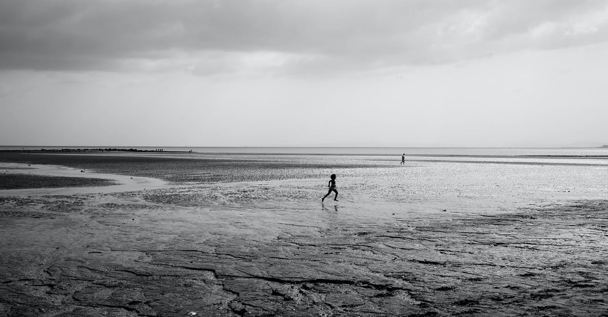 Running Low on Limestone - Silhouette of Running Child on Beach