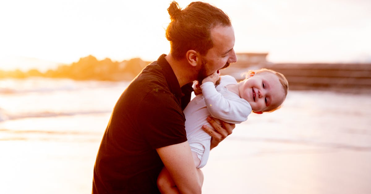 Send baby villagers through flowing water into soul sand elevator - Man in Black T-shirt Carrying Baby in White Onesie 