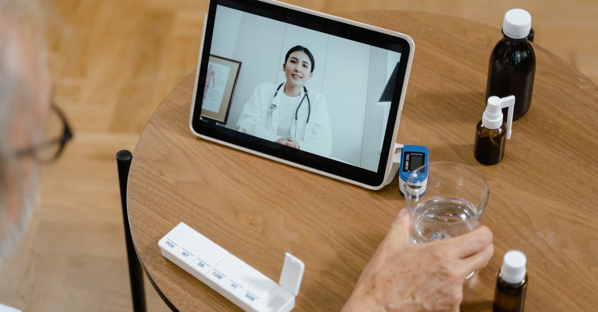 Shaking a virtual wiimote - Person Holding Black Ipad on Brown Wooden Table