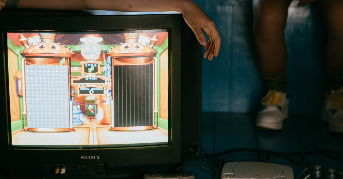 Share Xbox Game Pass between two consoles simultaneously - Crop unrecognizable female on modern monitor with video game on screen near ethnic partner