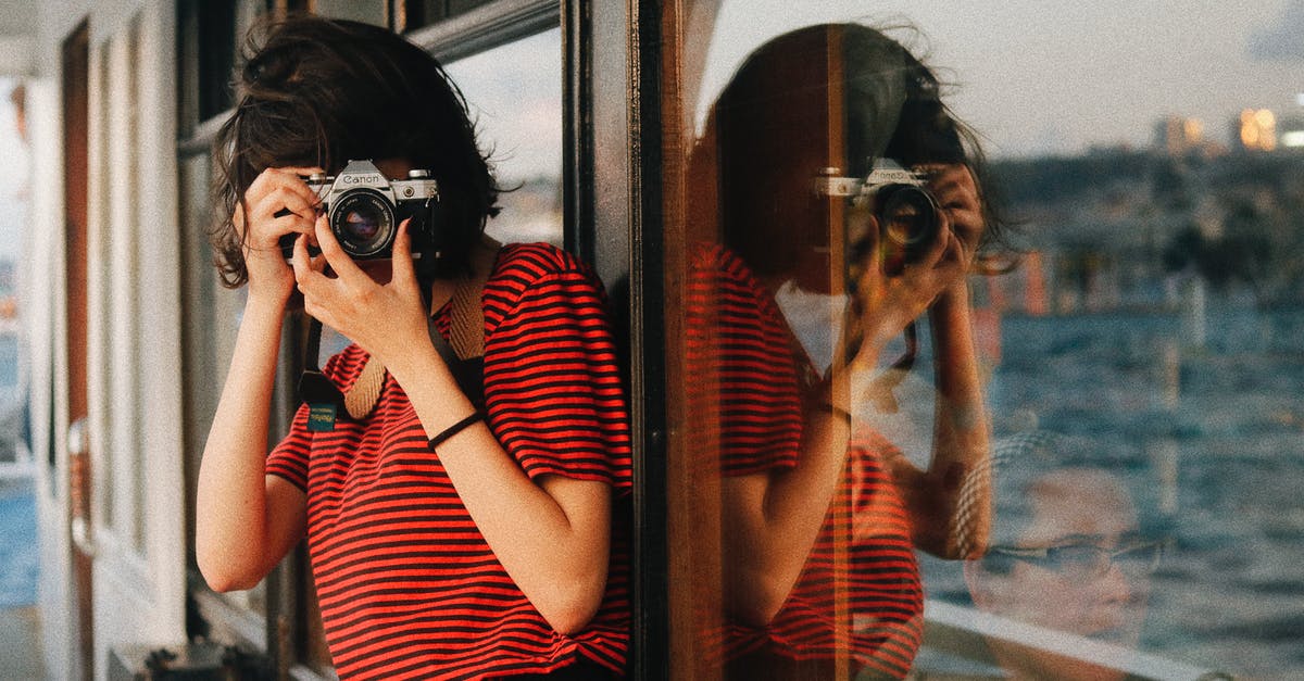 Ships defending hypergates instead of using them in Galactic Civilization III - Woman in casual clothes standing near windows on ship deck while taking pictures on camera