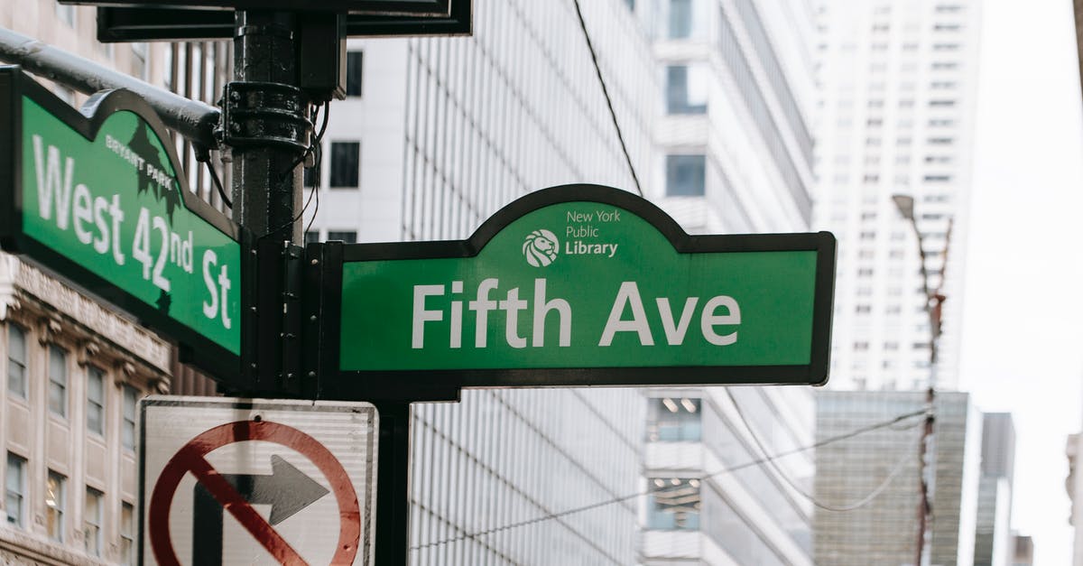 Signal directing on lanes - Metal post with direction indicator on avenue with high skyscrapers in New York