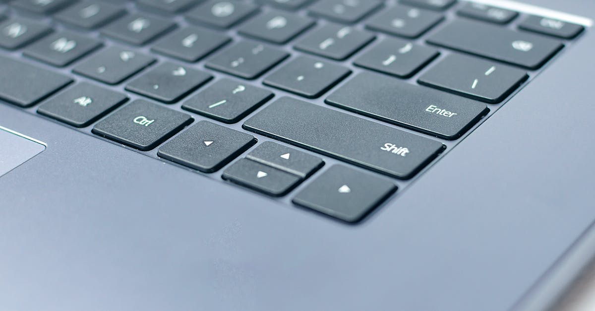 simulate a Enter key pressed on mouse click (ubuntu) - From above closeup of contemporary portable computer keyboard with words and symbols on black keys