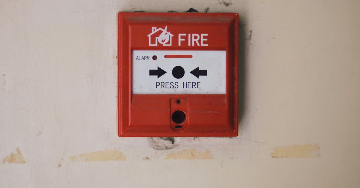 Squid detection system - Emergency safety fire detection system box for safety with inscription and push button placed on white wall in light room