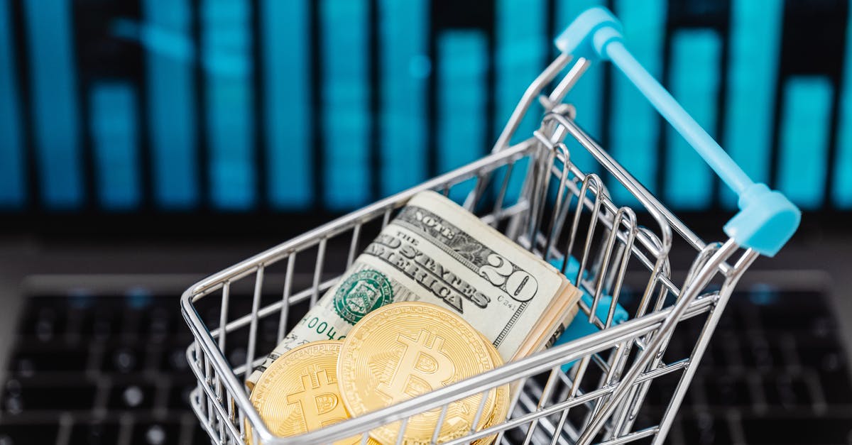 Stable club economy - Gold Bitcoin Coins and Cash in a Miniature Shopping Cart 