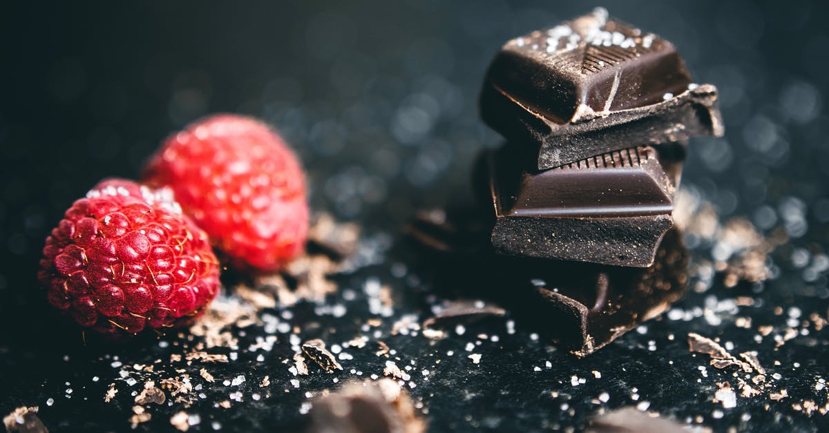 Stacked Booster Candy Crush - Close-Up Photo Of Stacked Chocolates Bars Beside Raspberries