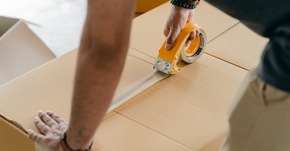 State of Decay cannot relocate homebase to trucking warehouse - Crop faceless man packing box with scotch tape