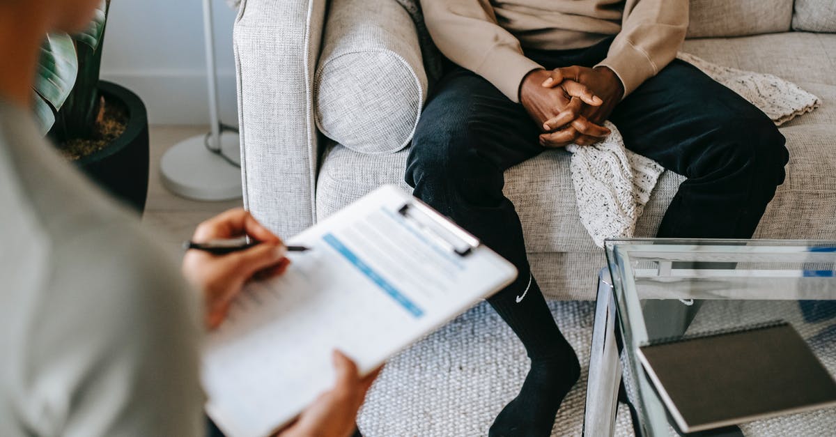 Strange issue with ping - Crop ethnic client discussing problems with anonymous psychologist