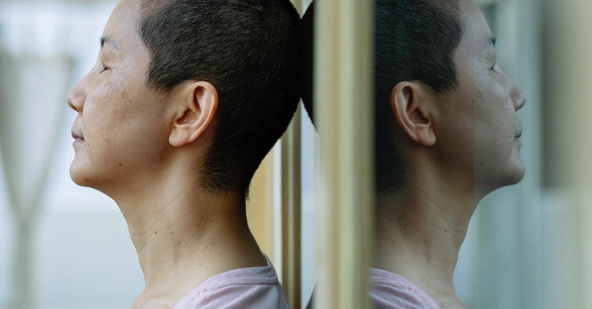 Stress recovery in town without abbey or tavern - Side view of ethnic ill female with short dark hair leaning on mirror at home