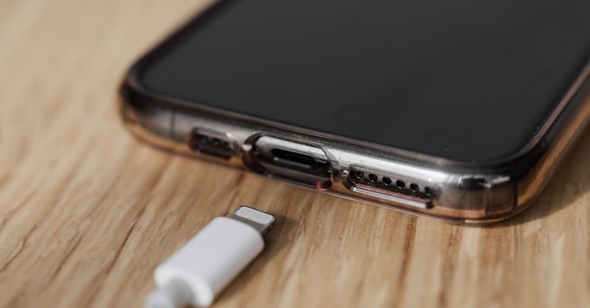 The Steam App Won't Connect to Wifi - Modern cellphone in transparent cover with closeup of charging input and mobile phone white charger cable usb connector on wooden table