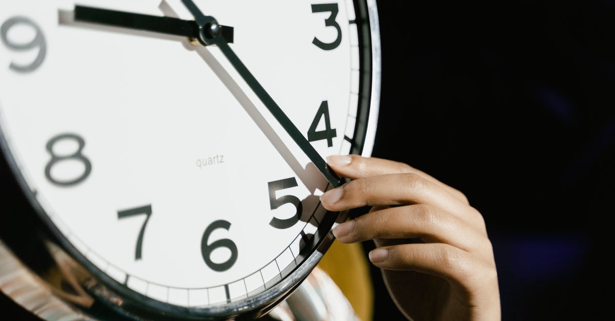 There’s only one hand on my Fez Clock - Person Holding White Analog Clock