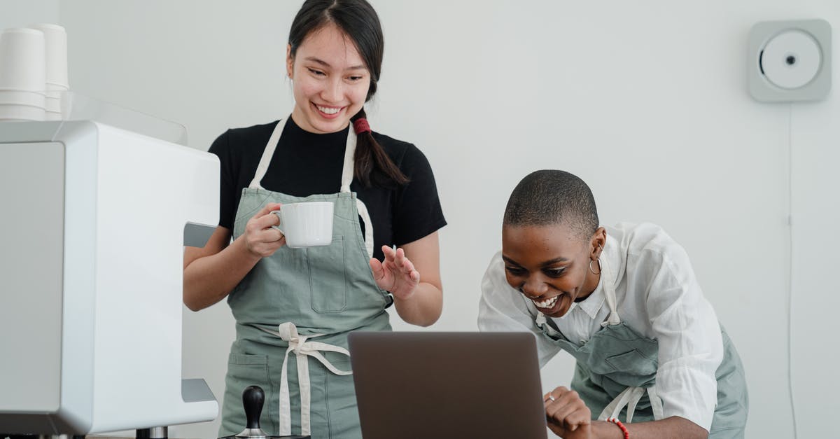 Thieves guild blindsighted/Under new management - Cheerful multiracial female baristas using modern laptop during coffee break