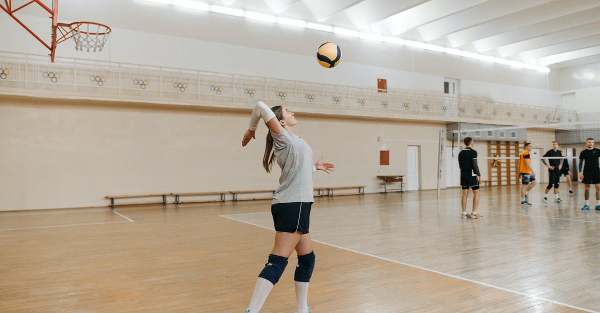 Use second server to serve data to players - Woman in White Shirt and Black Shorts Playing Volleyball