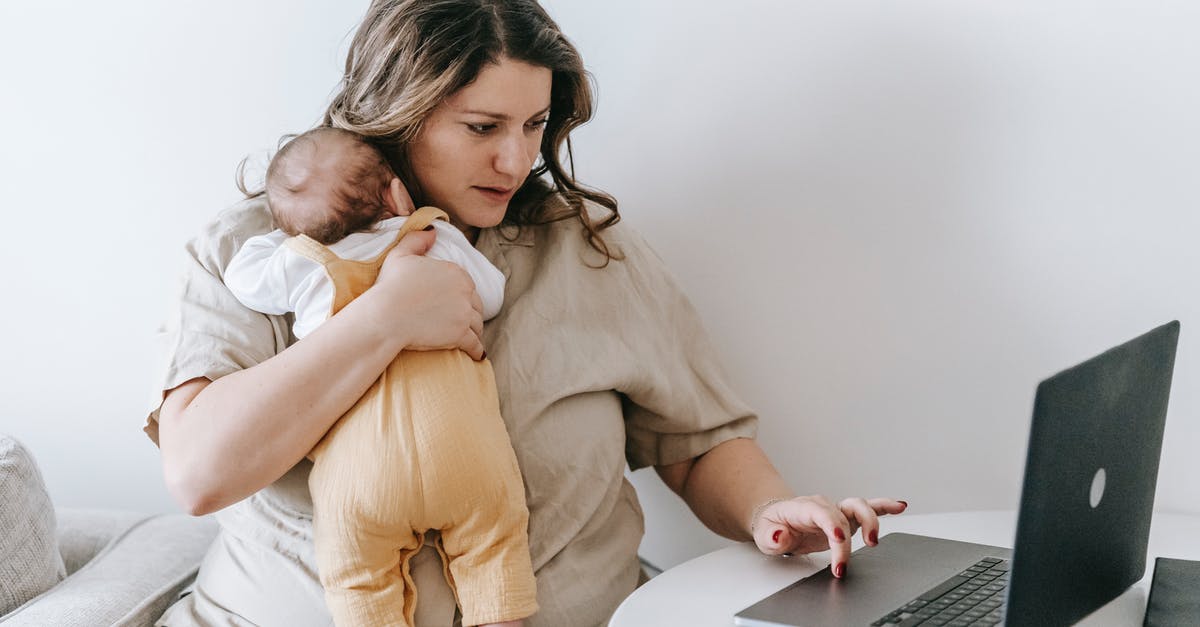 Using Carnage to generate Rage with weapons other than the Chaoseater - Concentrated young female freelancer embracing newborn while sitting at table and working remotely on laptop at home