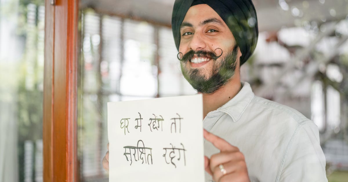 Wall of Flesh battle advice [duplicate] - Positive mature modern Sikh male in turban with curly mustache leaning against glass wall with sign in indian on paper sheet and looking at camera