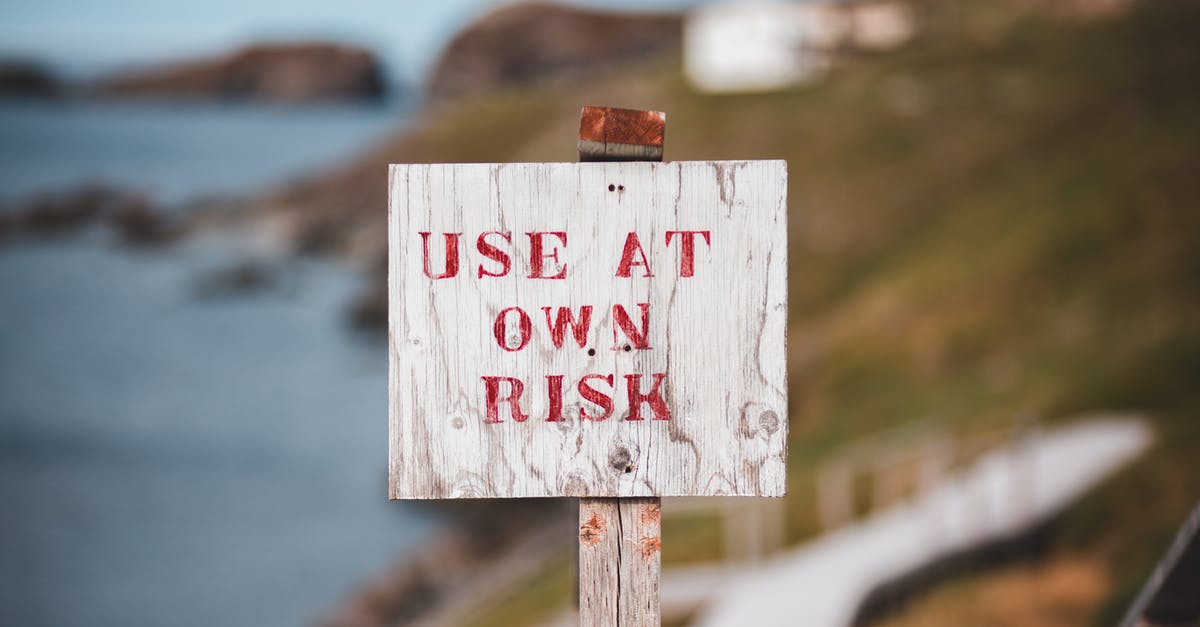 Warning sign while using scope as a tank destroyer - Sign with text Use At Own Risk on rocky seacoast