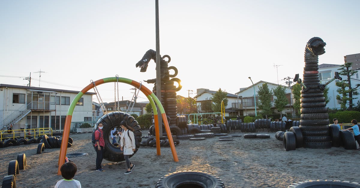 what's the proper use of gestures in Monster Hunter? - Small yard with huge monster creature figures constructed of old tyres on playground full of children