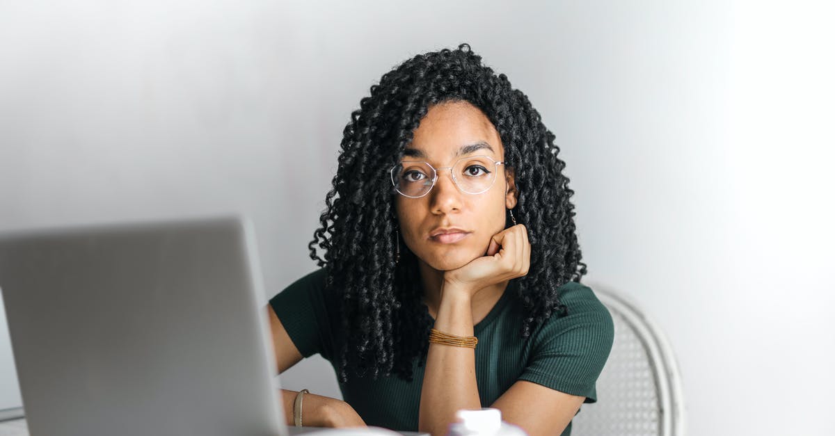 What's the use of fence? - Serious ethnic young woman using laptop at home