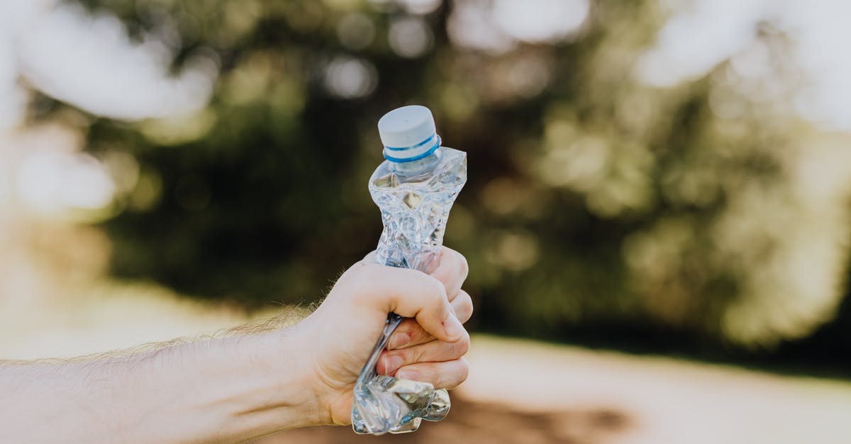 What are body parts used for? - Crop man crushing plastic bottle