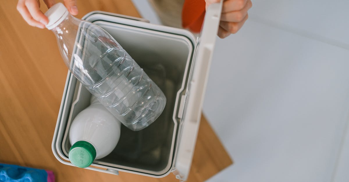 What are body parts used for? - Top view of crop anonymous person opening container while disposing plastics bottle on wooden table