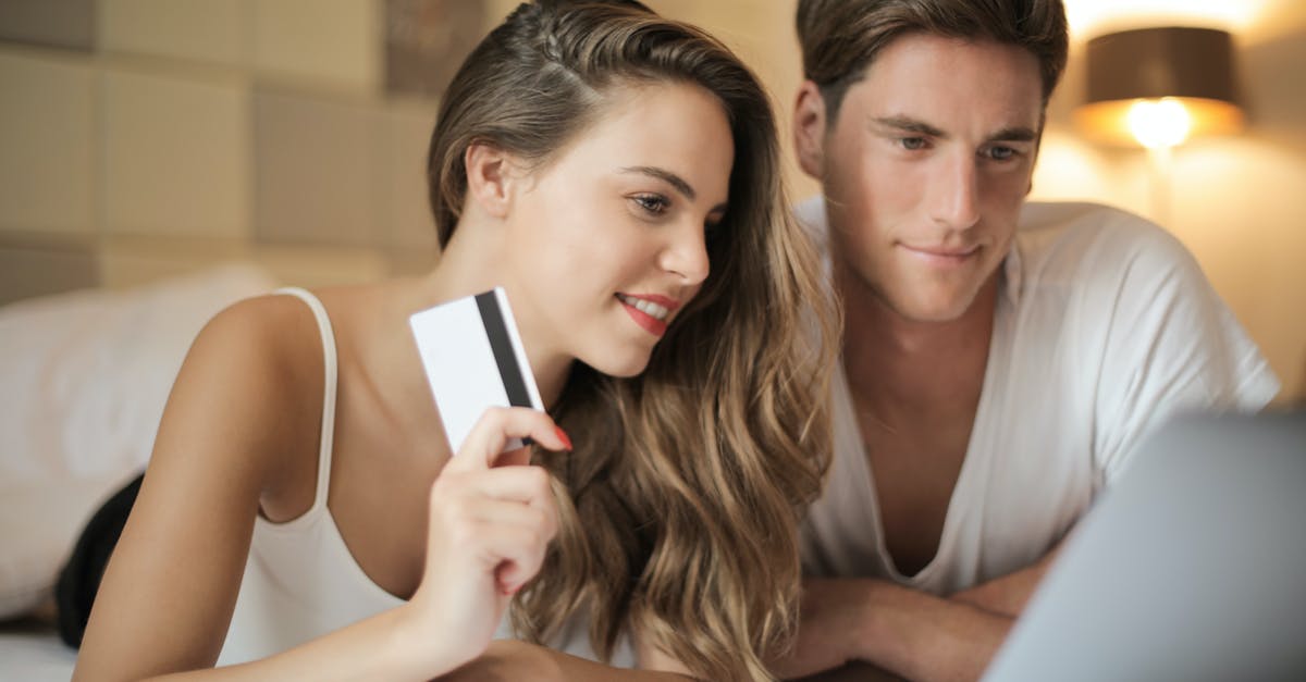 What are Hegemony Credits used for? - Cheerful couple making online purchases at home