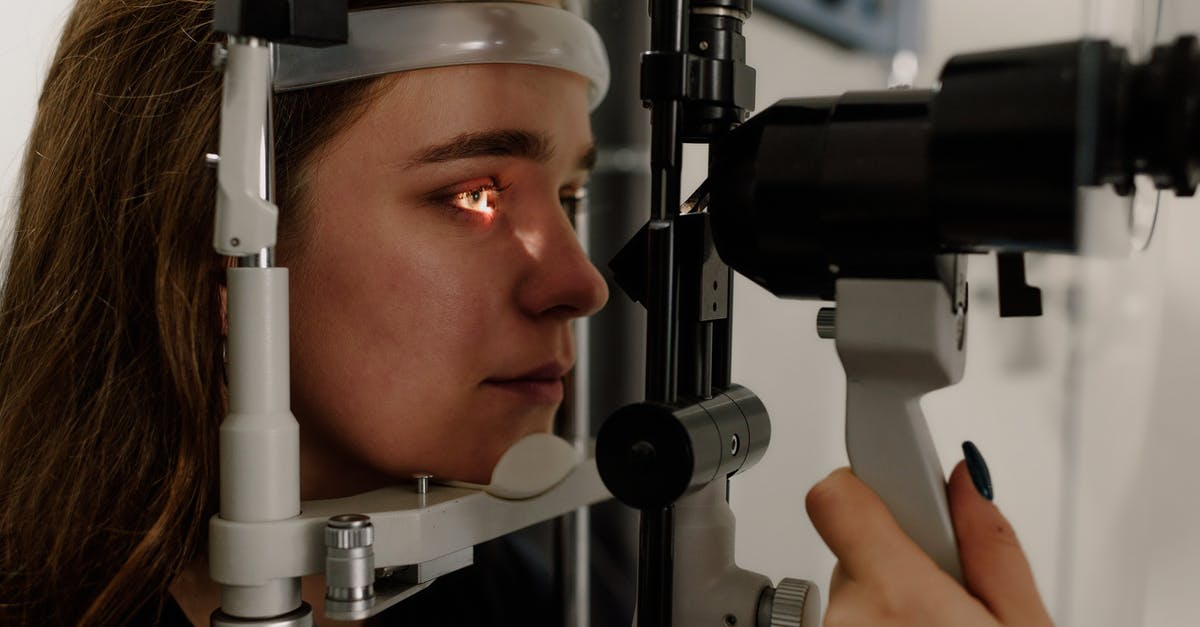 What are items that help us to get vision spells? - Woman testing vision on microscope