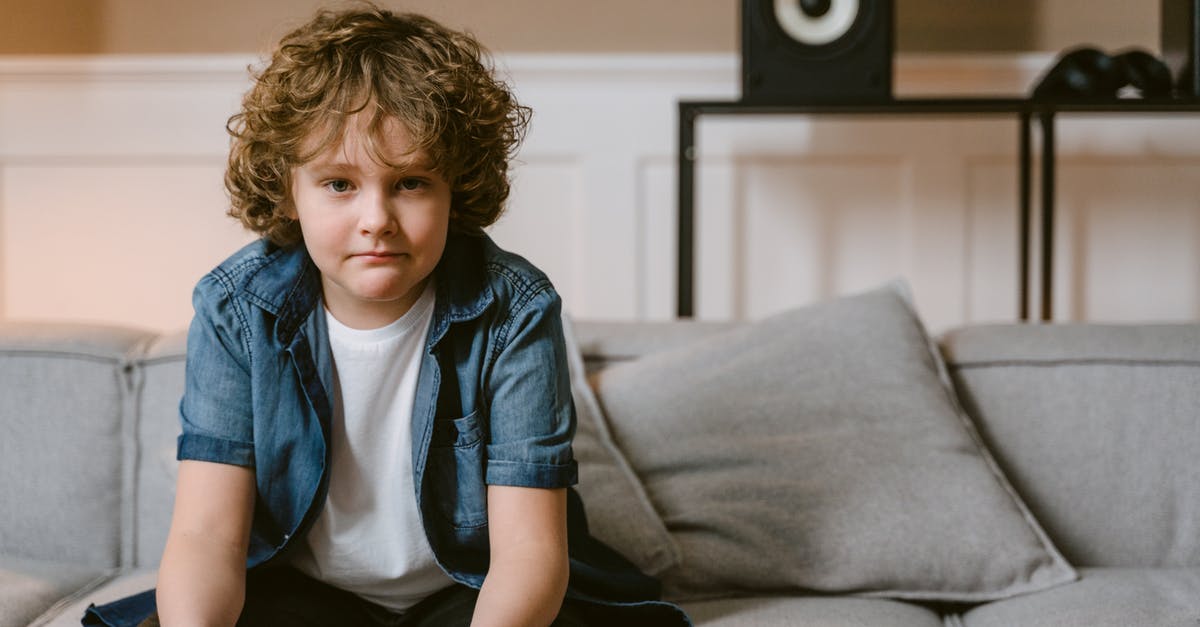 What are some good gaming strategies for slither.io? - Boy Sitting on Couch Holding a Game Controller