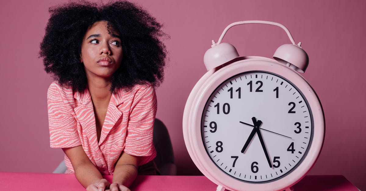 What are the benefits of waiting to drop troops second? - Woman in Pink Long Sleeve Shirt Sitting Beside White and Pink Alarm Clock