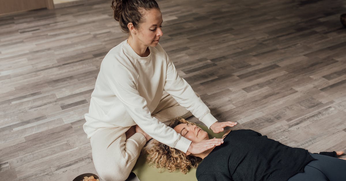 What are the most cost-effective healing / energy items? - Woman in White Sweater and White Pants Sitting on Wooden Floor