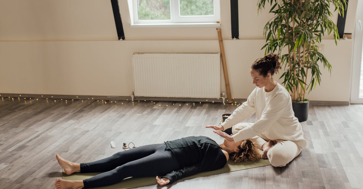 What are the most cost-effective healing / energy items? - Woman Sitting beside Woman Lying on the Floor