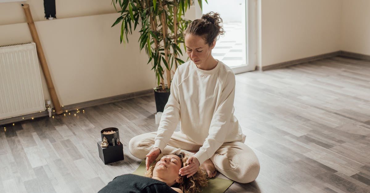 What are the most cost-effective healing / energy items? - Woman in White Sweater Sitting on Wooden Floor