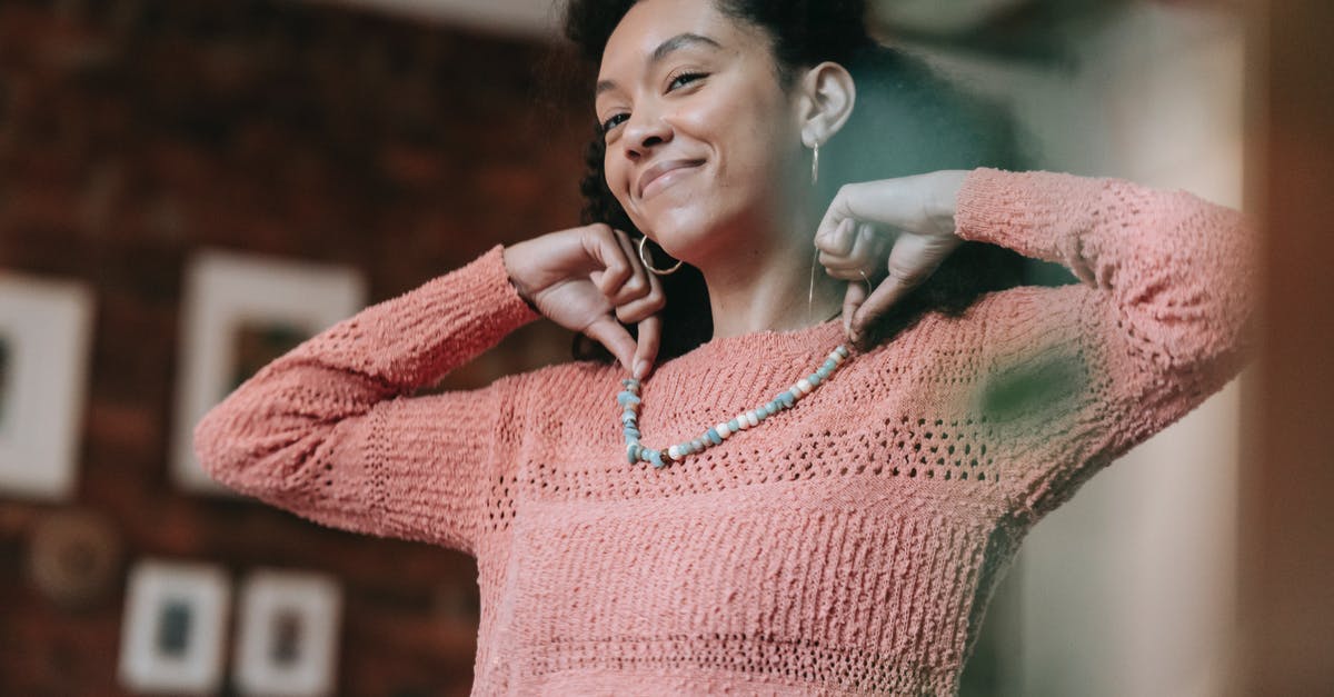 What are the origins of the Master Sword? - Pleasant black woman putting on mineral necklace