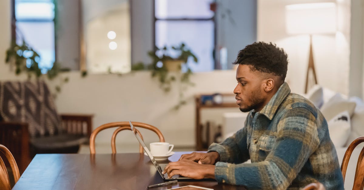 What are the type of view projections in League of Legend, or Dota 2? - Concentrated black man working on laptop at home office What are the type of view projections in League of Legend, or Dota 2? - Concentrated black man working on laptop at home office