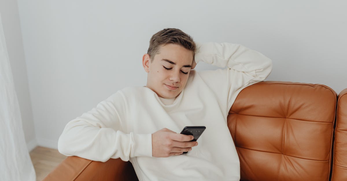 What are the x, y, and z in the /testforblocks command? - Teenage Boy Sitting on the Sofa and Using a Smart Phone What are the x, y, and z in the /testforblocks command? - Teenage Boy Sitting on the Sofa and Using a Smart Phone